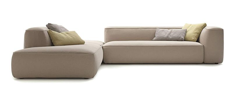 Beige sectional sofa with pillows.