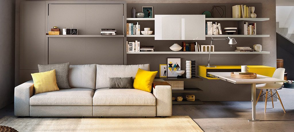 Grey sofa with yellow pillows in living room.