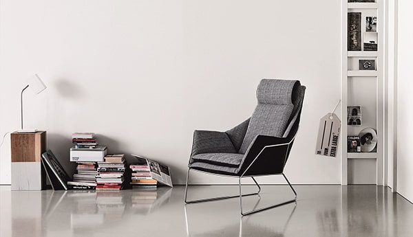 Modern grey armchair with metal frame.