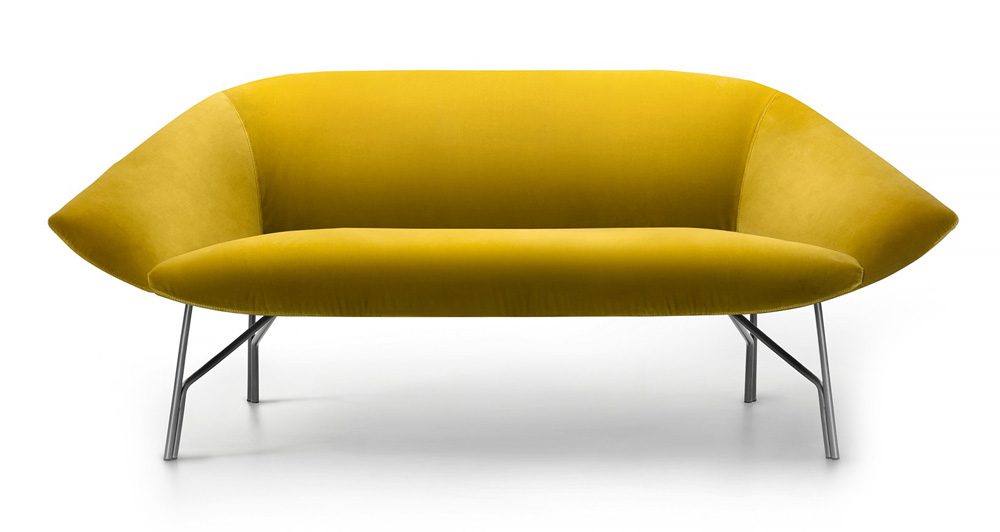 Yellow velvet sofa with metal legs.