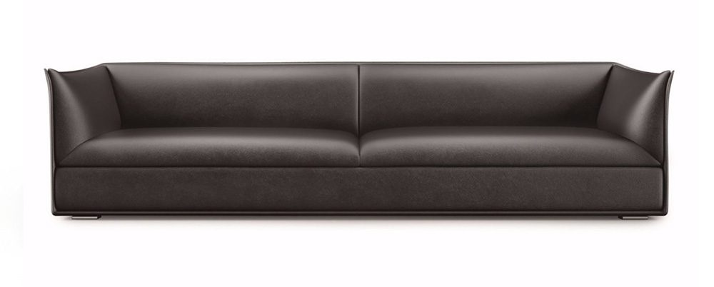 Black leather sofa with flared arms.