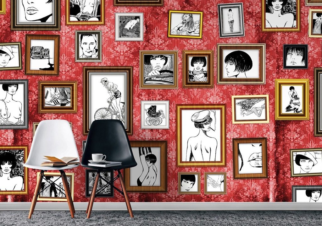 Red wall with framed black and white drawings.