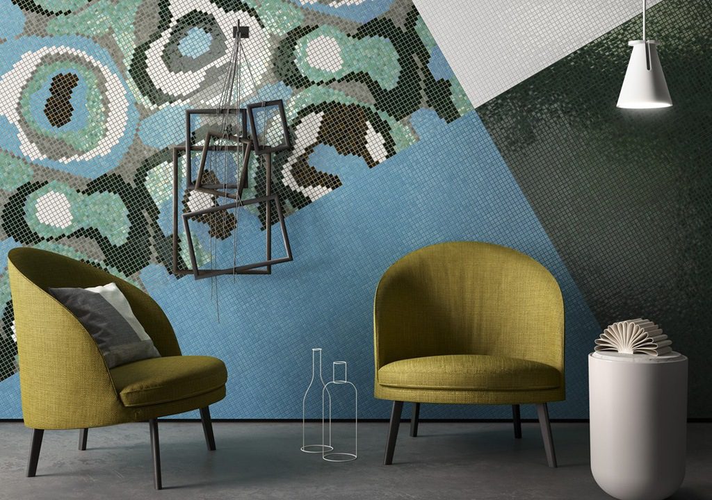 Mosaic tiled wall with two chairs and a lamp.