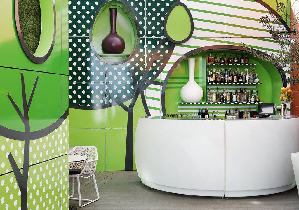 White bar with green and white wall art.