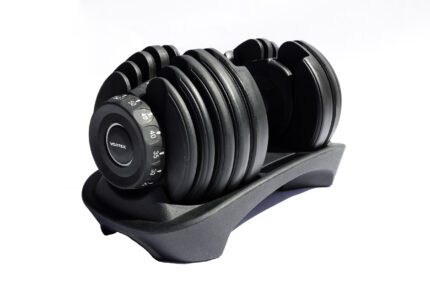 Adjustable weight dumbbell with stand.