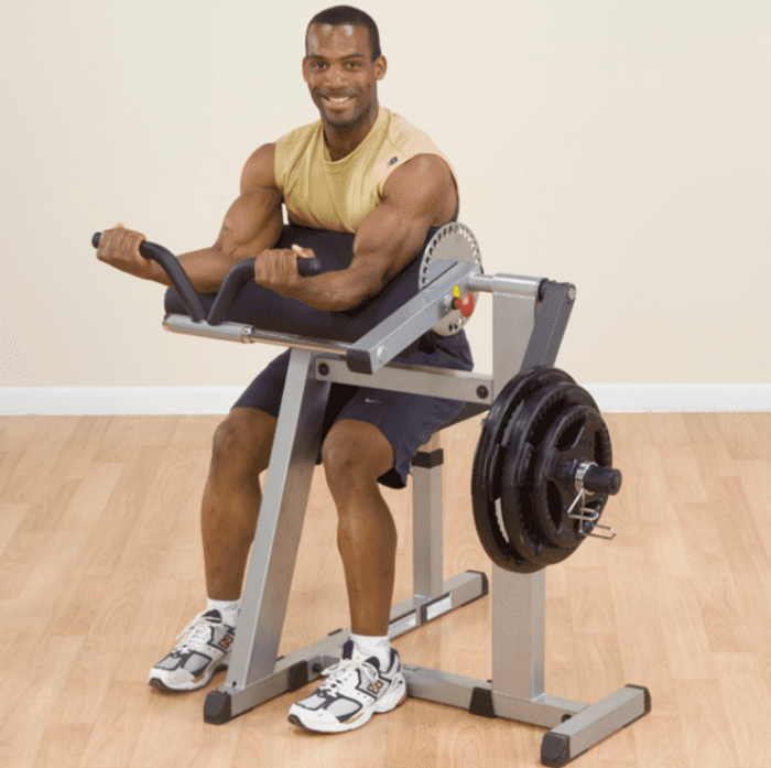 Man using a preacher curl machine.