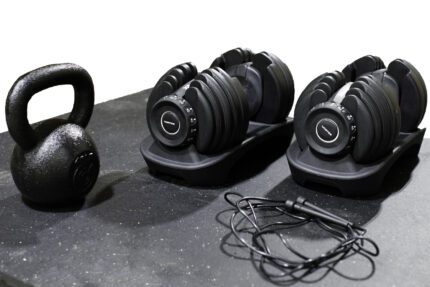 Black kettlebell, adjustable dumbbells, jump rope.