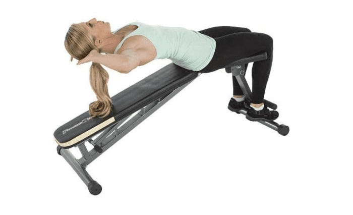 Woman working out on an incline bench.