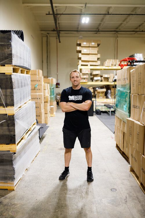 Man standing in a warehouse with boxes.
