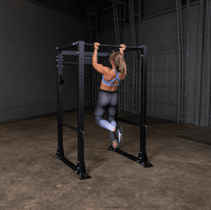 Woman doing pull-ups on a rack.