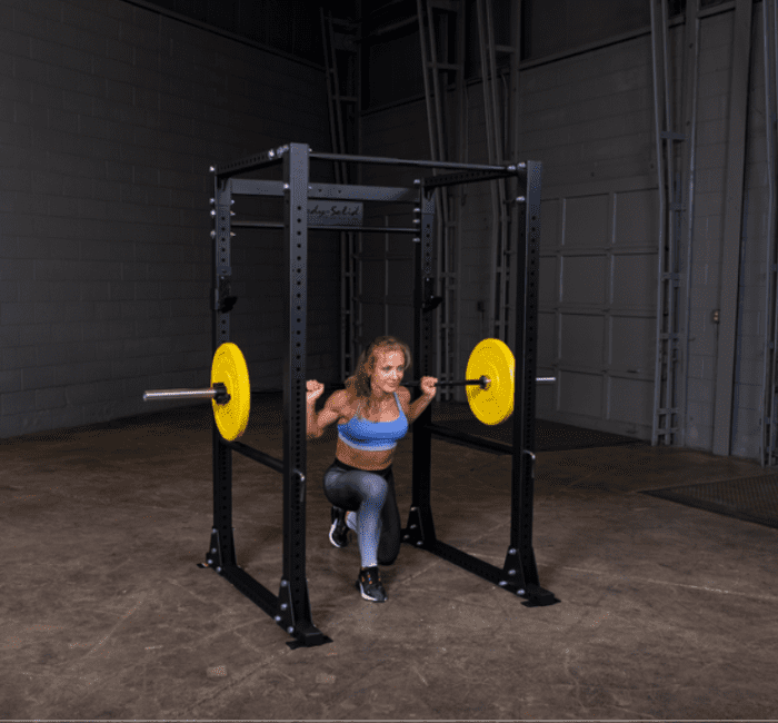 Woman lifting weights in a gym.