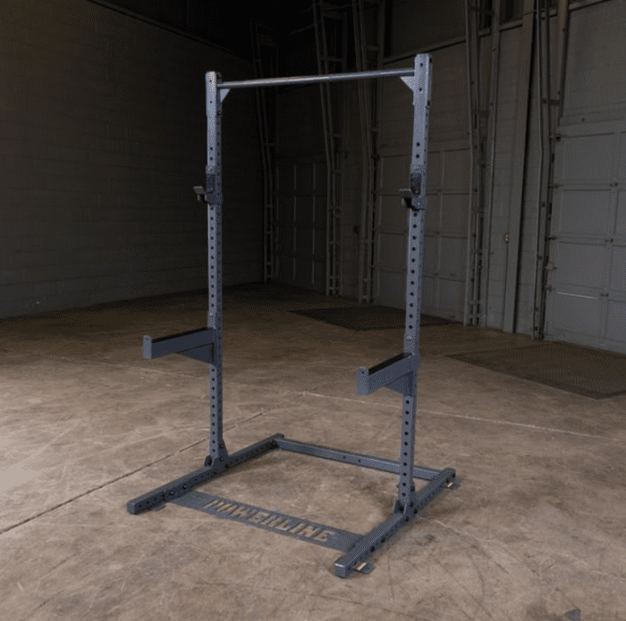 Gray power rack with safety bars.