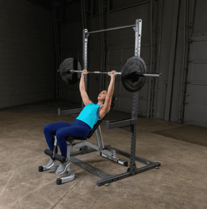 Woman bench pressing with a barbell.