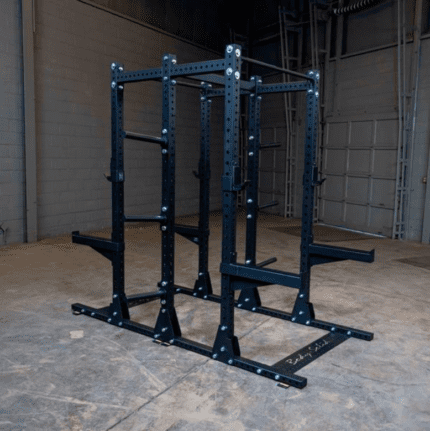 Black steel squat rack with safety bars.