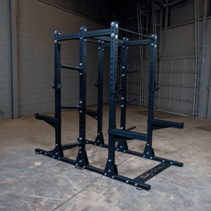 Black steel squat rack with safety bars.