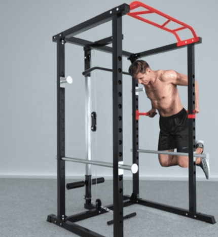 Man doing pull-ups on a squat rack.