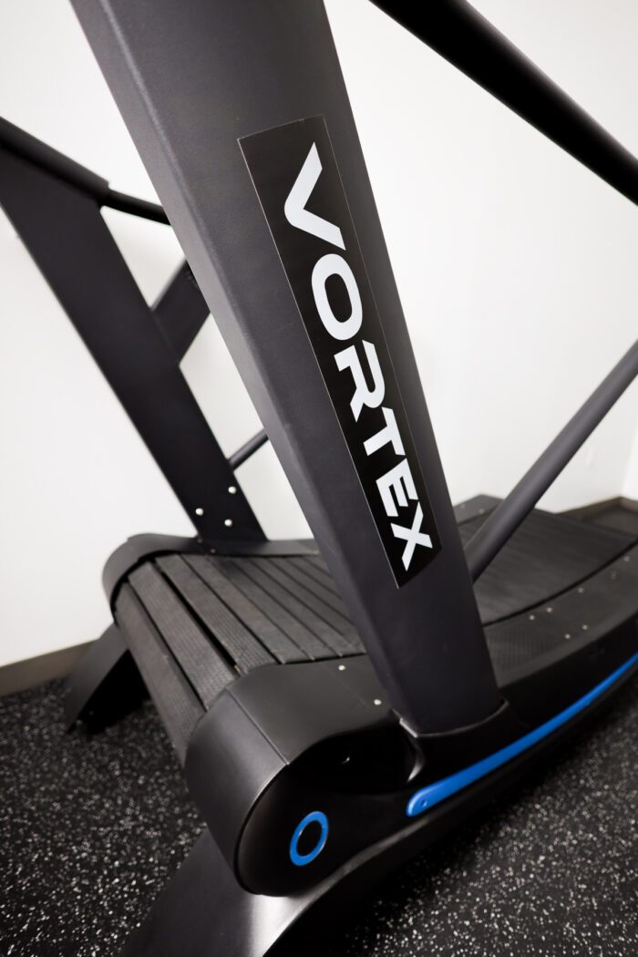 Black Vortex curved treadmill in gym.