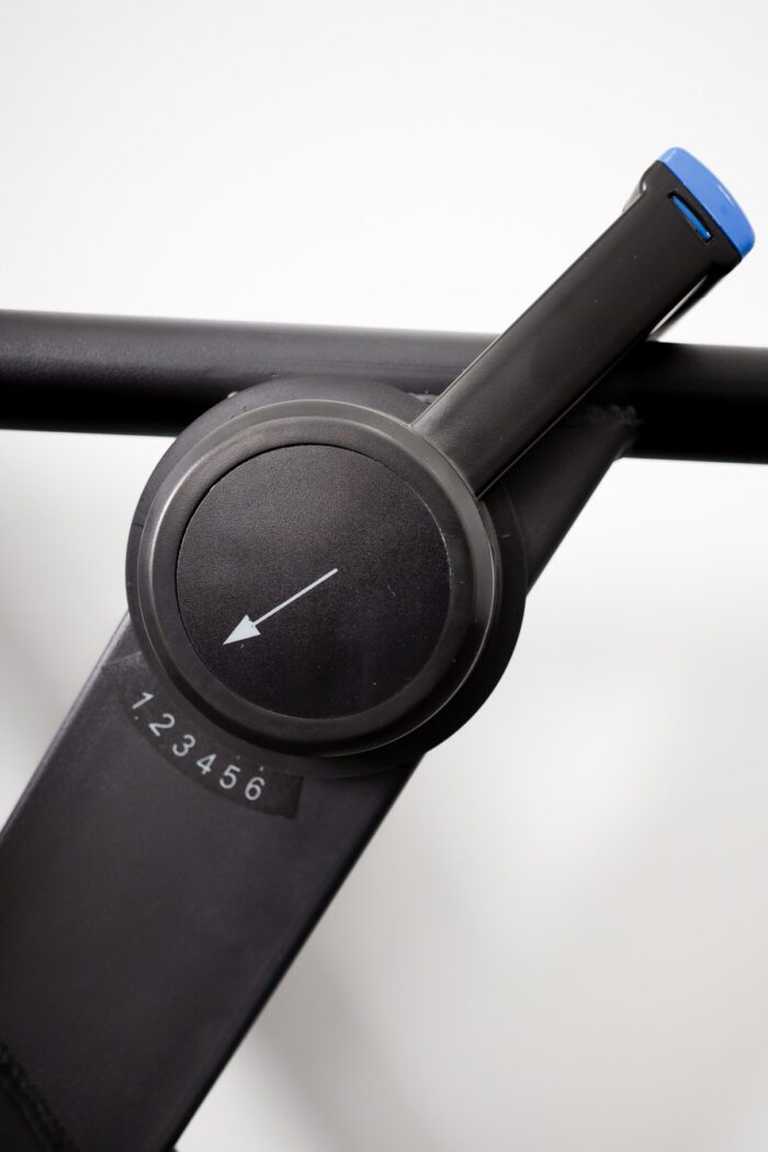 Black exercise equipment with a numbered dial.