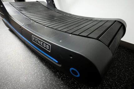 Black curved treadmill with fitness logo.