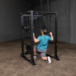Man doing lat pulldown exercise in gym.
