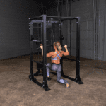 Woman using lat pulldown machine in gym.