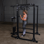 Woman doing bicep curls in a gym.