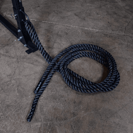 Black battle rope on concrete floor.