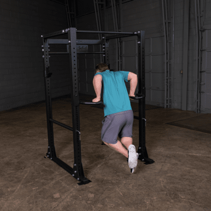 Man doing dips on a dip bar rack.