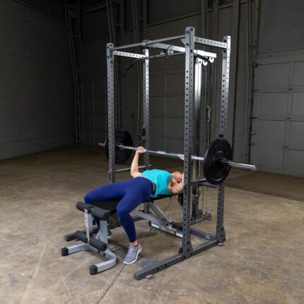 Woman weightlifting in a power rack.