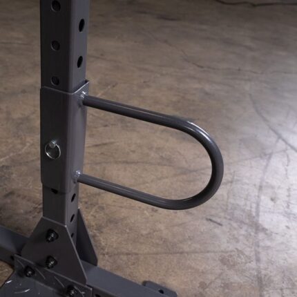 Close up of a gym rack's safety bar.