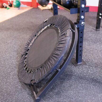 Black mini trampoline on a rack.