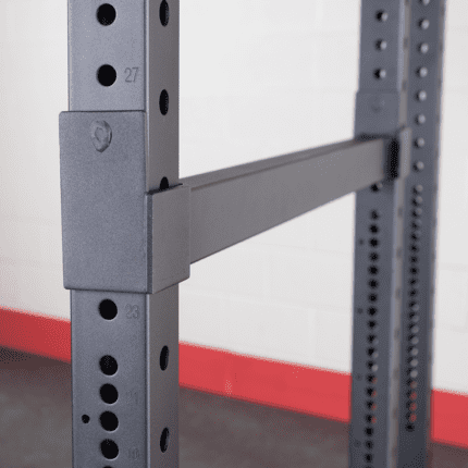 Close up of a weight rack with holes.