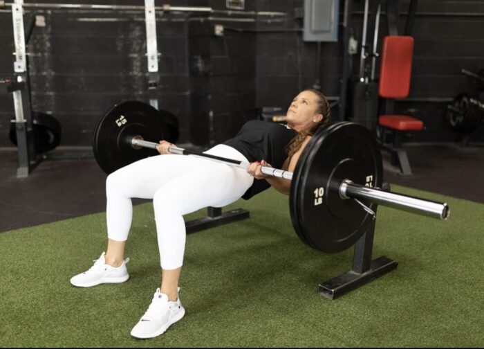 Woman lifting weights at the gym.