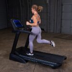 Woman running on black Endurance T25 treadmill.