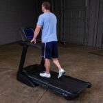 Man running on a black treadmill.