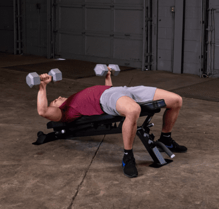 Man weight training on a bench press.