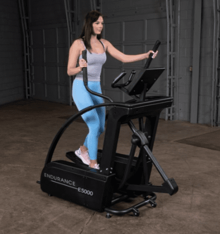 Woman exercising on an Endurance E5000 elliptical.