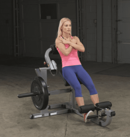 Woman exercising on a seated leg curl machine.