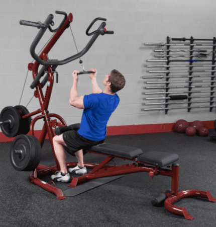 Man working out on a lat pulldown machine.