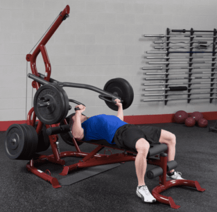 Man weightlifting on a red bench.