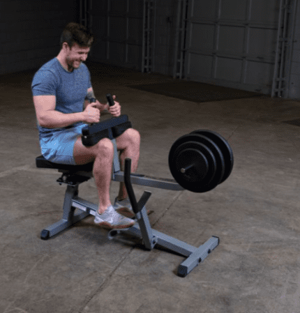 Man exercising on leg press machine.