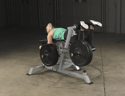 Woman using a leg extension machine.