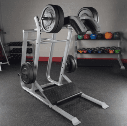 Silver leg press machine with weight plates.