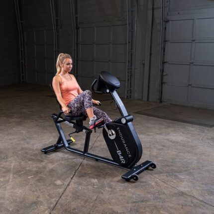 Woman exercising on a black recumbent bike.