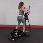 Woman exercising on a red elliptical machine.