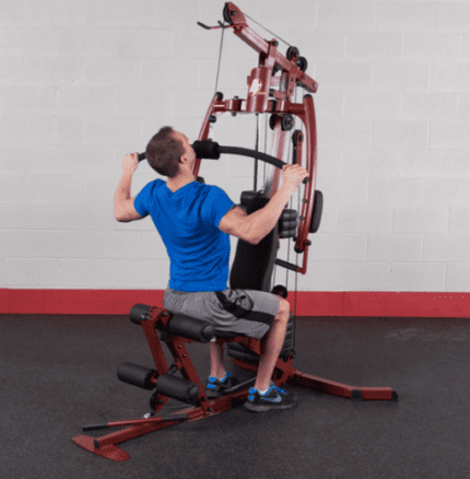 Man exercising on a home gym machine.