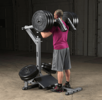 Man lifting weights on a squat machine.