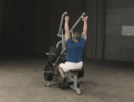 Man using lat pulldown machine for workout.