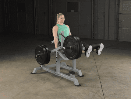 Woman using leg extension machine.