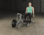 Woman exercising on a leg extension machine.
